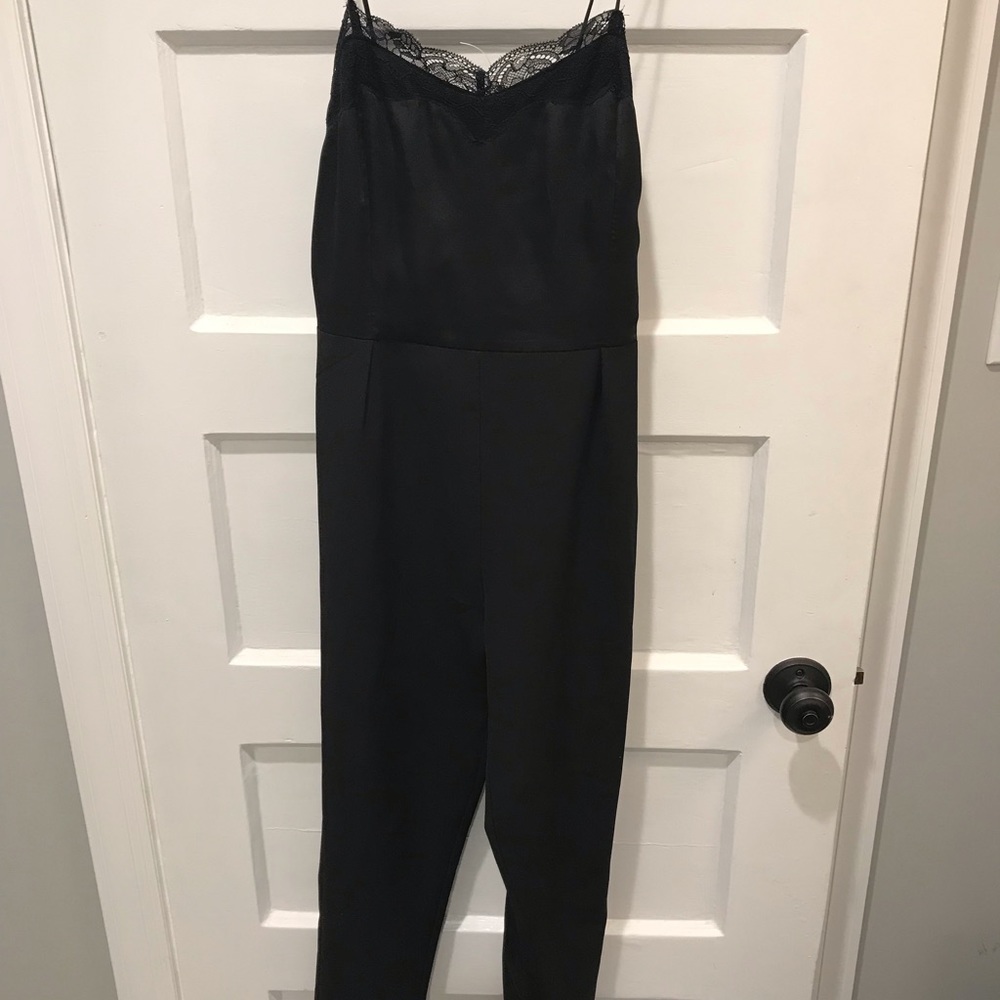 Black jumpsuit. Satin top and trouser type pants.